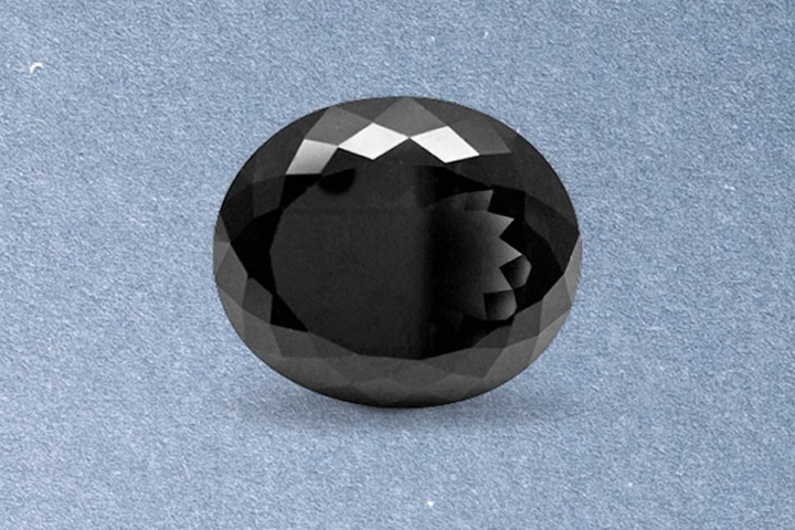 Kay oval-cut black onyx gemstone featuring deep jet-black color, faceted surface, and polished luster on a light neutral background