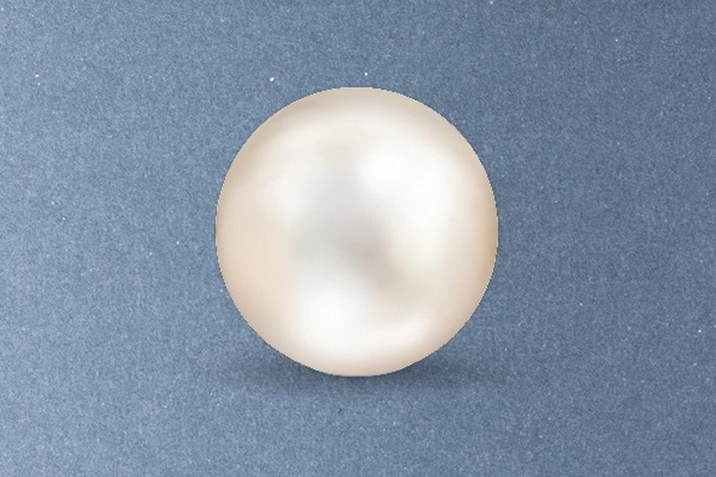 Kay cultured freshwater pearl featuring soft white luster, smooth surface, and classic round shape on a light neutral background