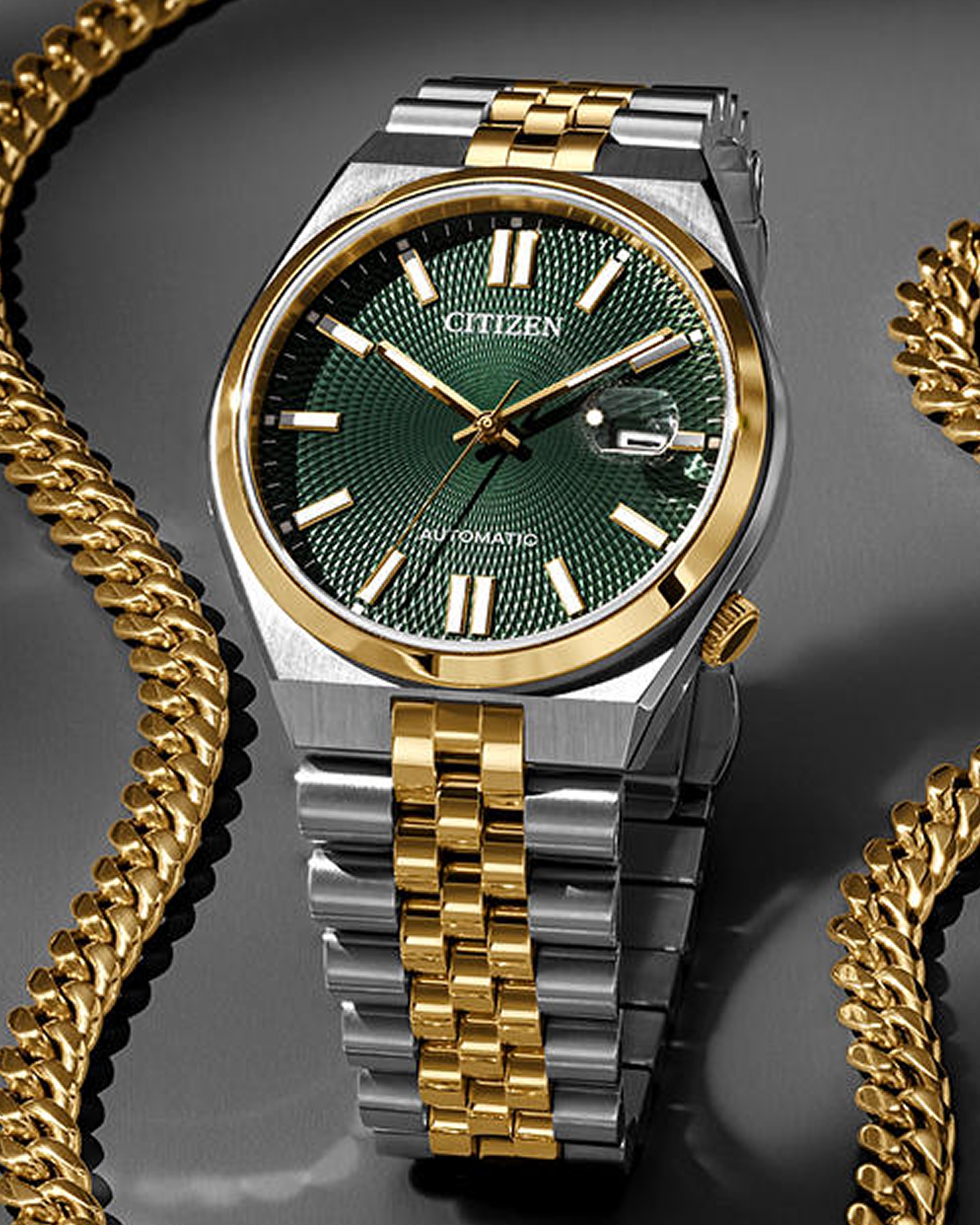 Kay two-tone Citizen automatic watch with green textured dial, gold and silver bracelet, styled alongside gold curb chain jewelry