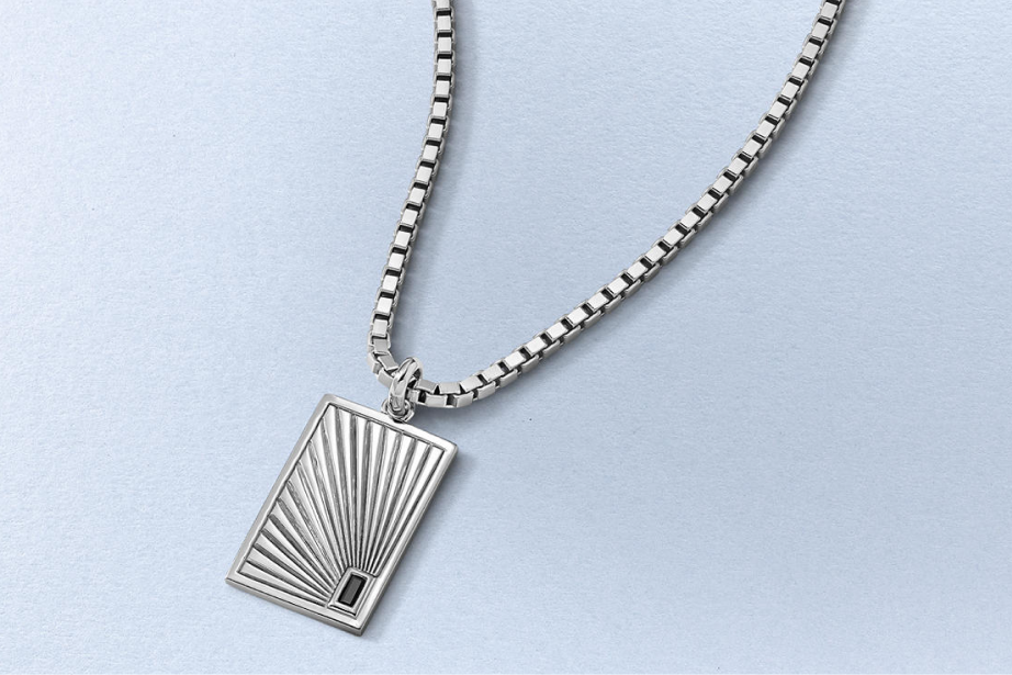 Kay stainless steel dog tag pendant necklace with a radiant sunburst design on a polished box chain