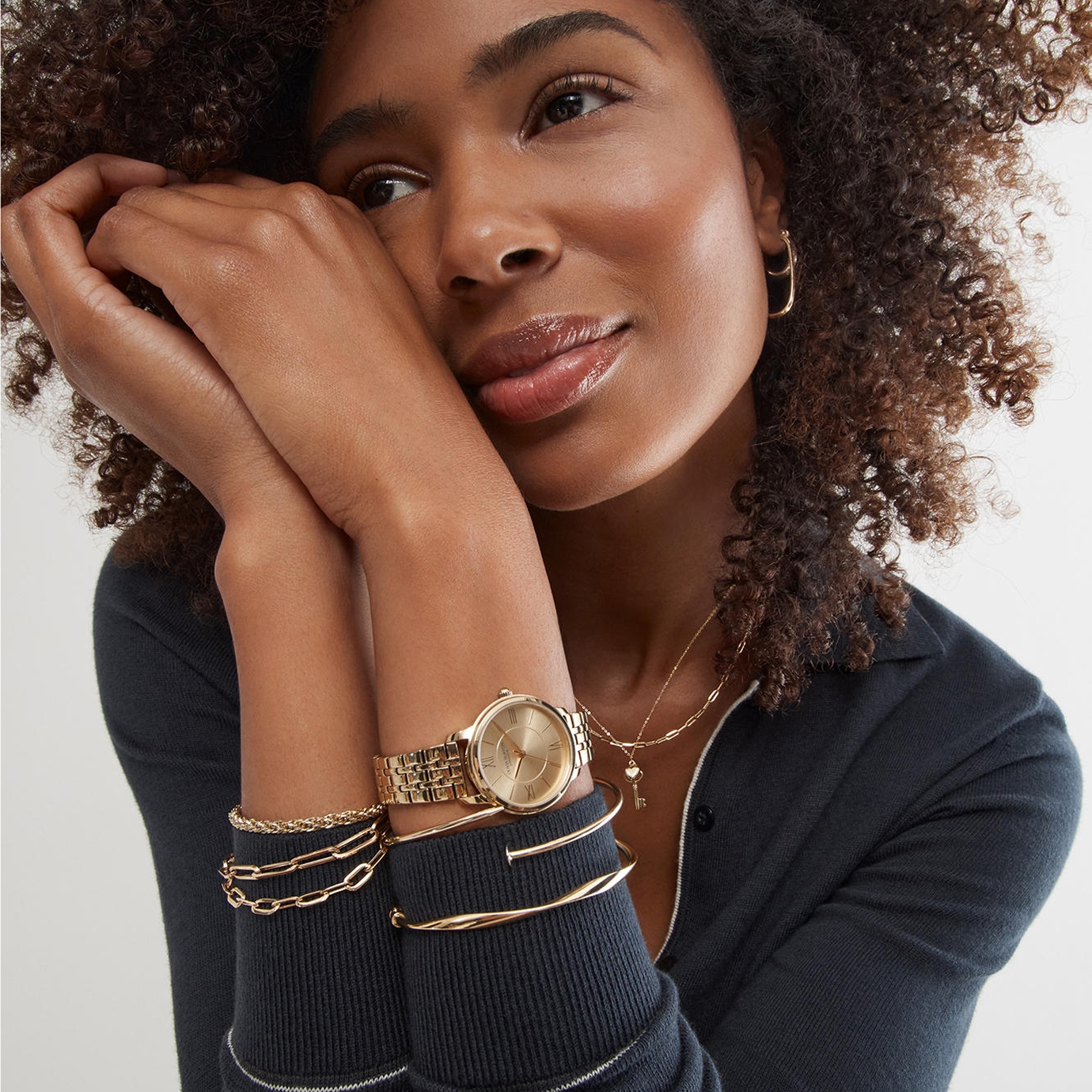 Woman wearing various jewelry pieces by KAY.