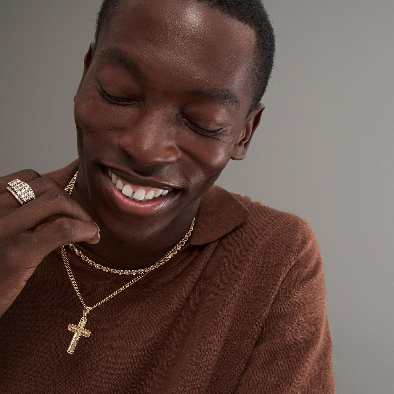 Man wearing various styles of gold and diamond jewelry by KAY.