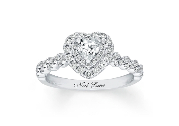 A heart-shaped diamond engagement ring with a vintage setting