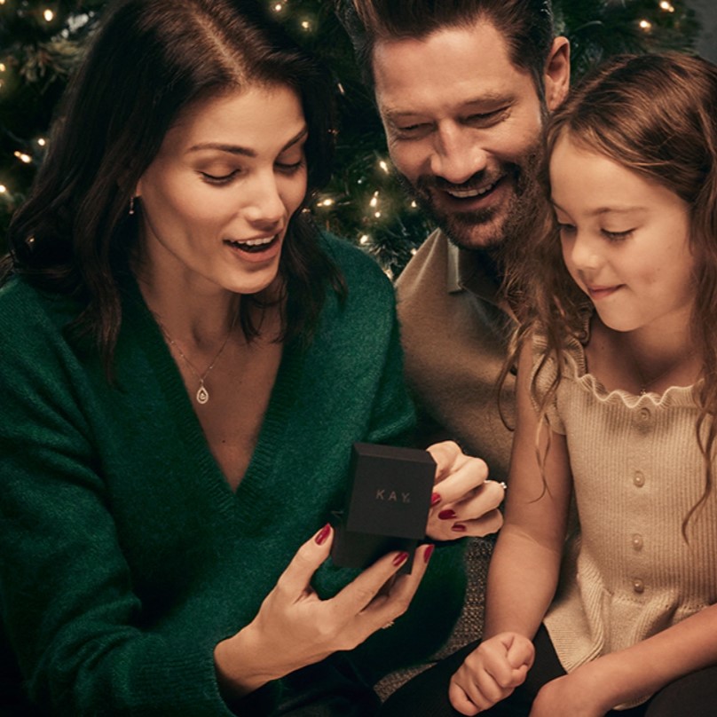 Image of family looking at Kay gift box