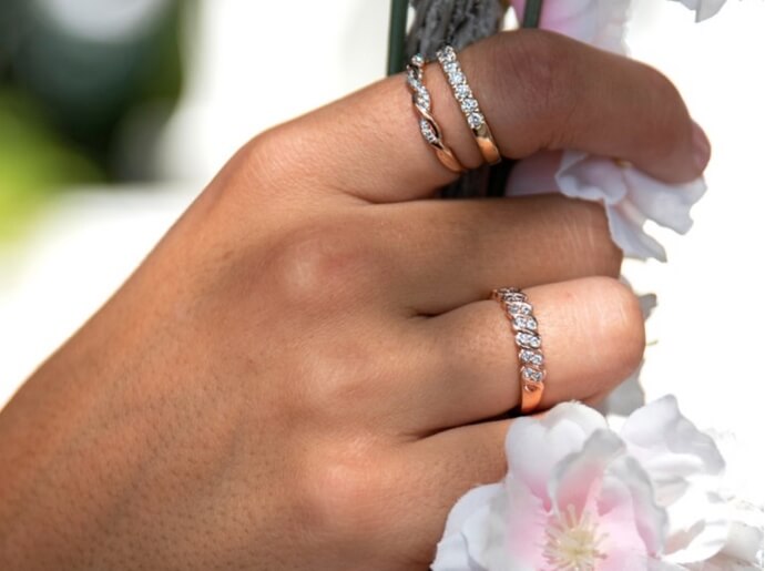 Hand featuring stacked diamond bands