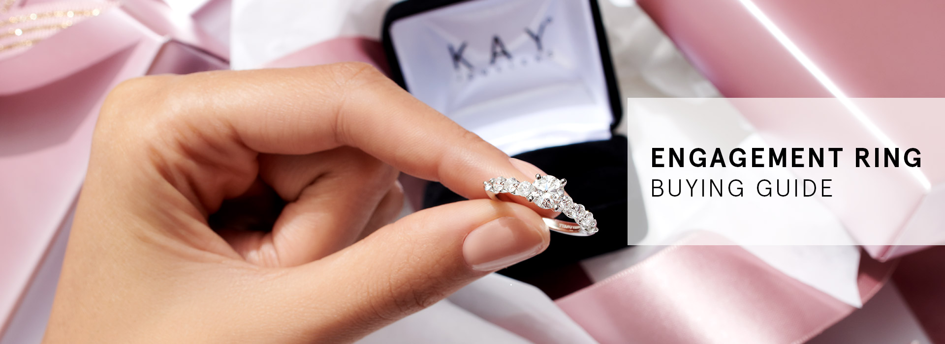 Lady holding a white gold diamond engagement ring from KAY
