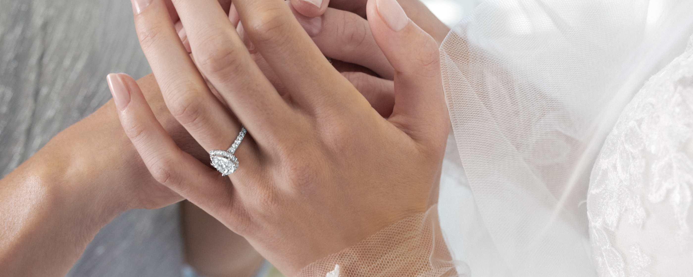 Closeup of a diamond engagement ring on a brides hand