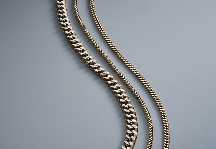 Three gold chains laying side by side from KAY.