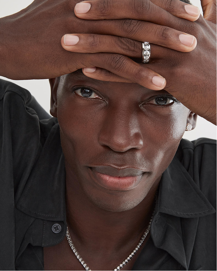 A man showing off his white gold and diamond ring from KAY.