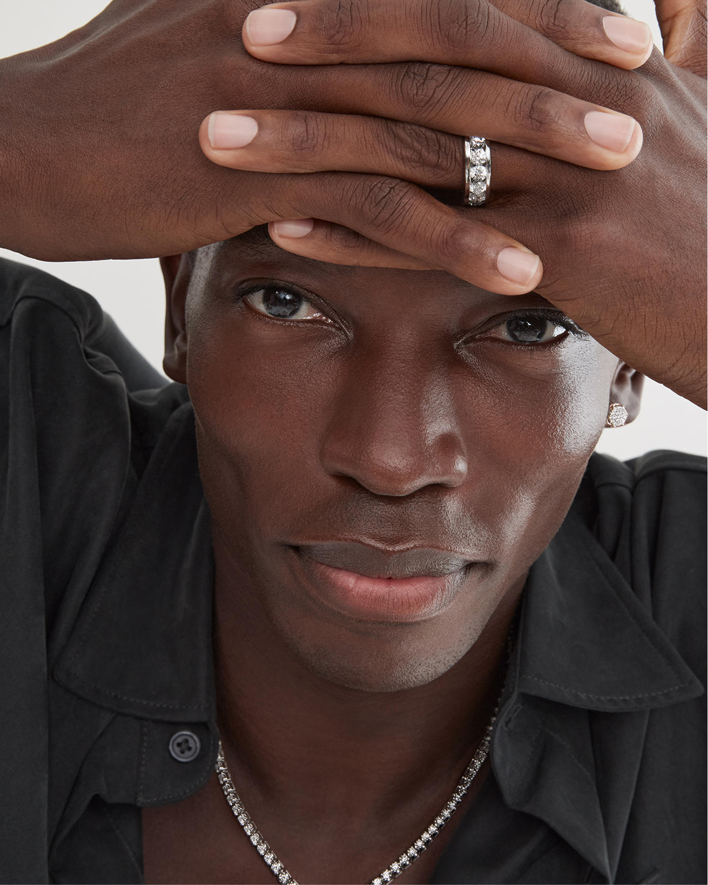 A man showing off his white gold and diamond ring from KAY.
