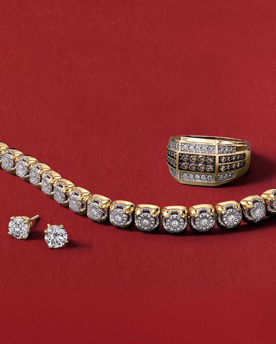 A set of diamond jewelry including a pair of studs, a tennis bracelet, and a gold ring from KAY.