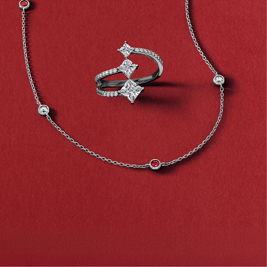 A gemstone necklace and matching silver diamond ring from KAY.