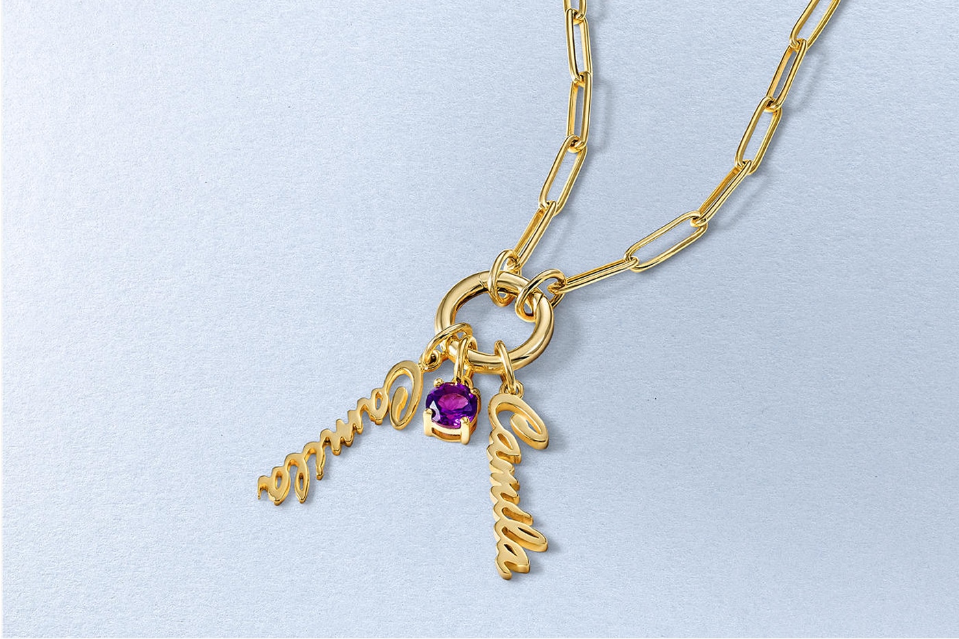 A gold, link, chain with two personalized name pendants and an amethyst, from KAY.
