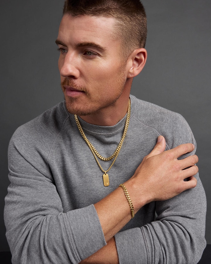A man showing off his gold chain necklaces and bracelet by JAXXON from KAY.