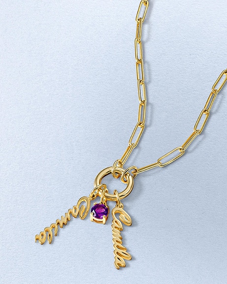 A gold link chain with a personalized name charm and amethyst pendant from KAY.