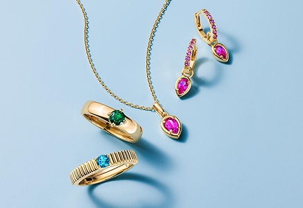 A gold diamond pendant necklace and gemstone earrings from STUDIO BY KAY