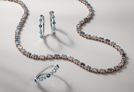 A set of sapphire studded jewelry including a necklace, earrings and ring by Le Vian.