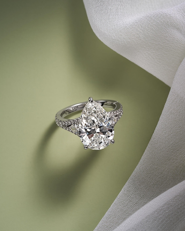 A silver, diamond engagement ring with a pear-cut diamond from KAY.