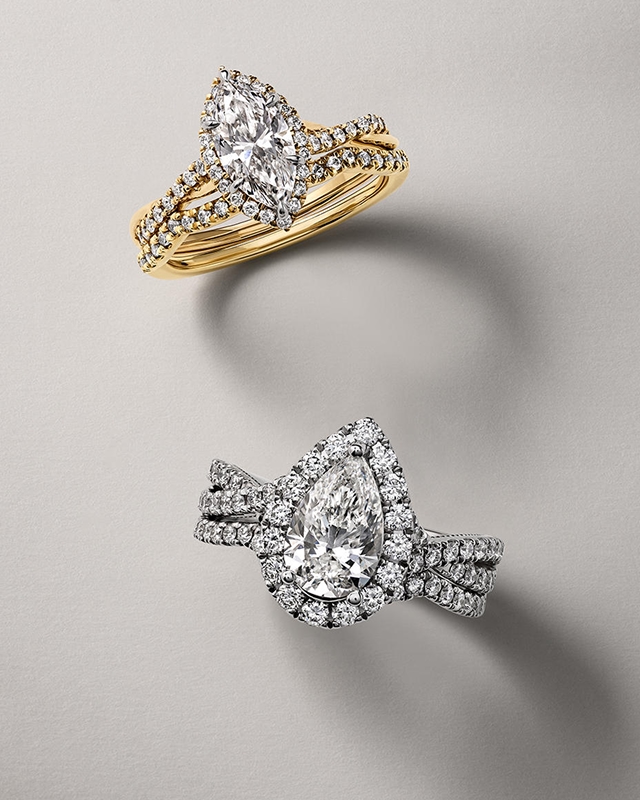 A gold band, marquise-cut diamond engagement ring and a silver band, pear-cut diamond engagement ring by KAY.