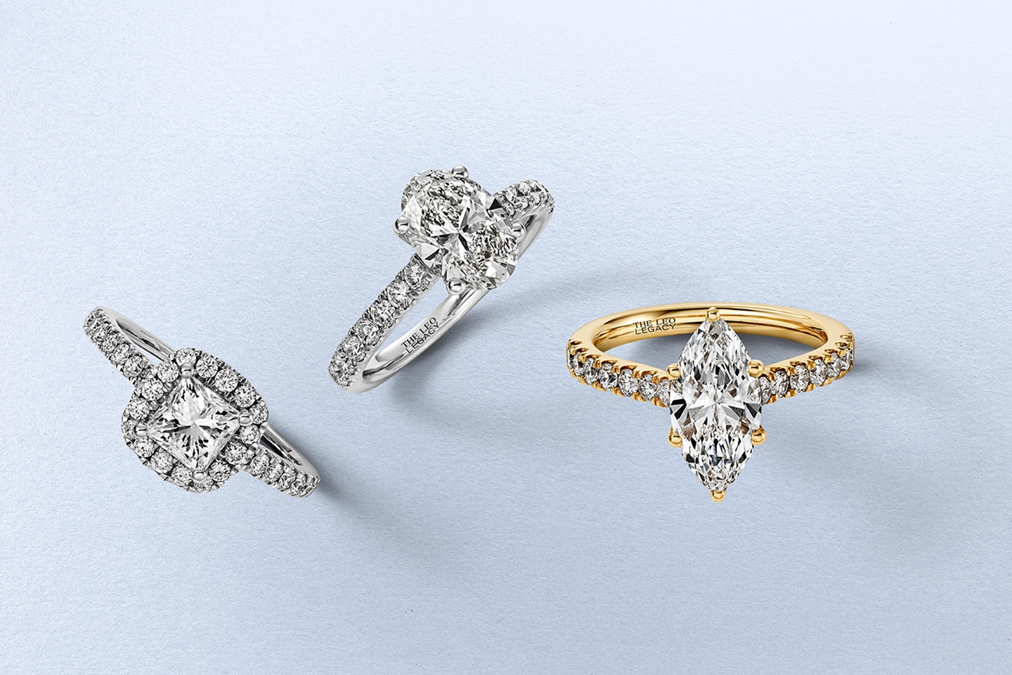 Three diamond rings in varying stone shapes and band colors from KAY.