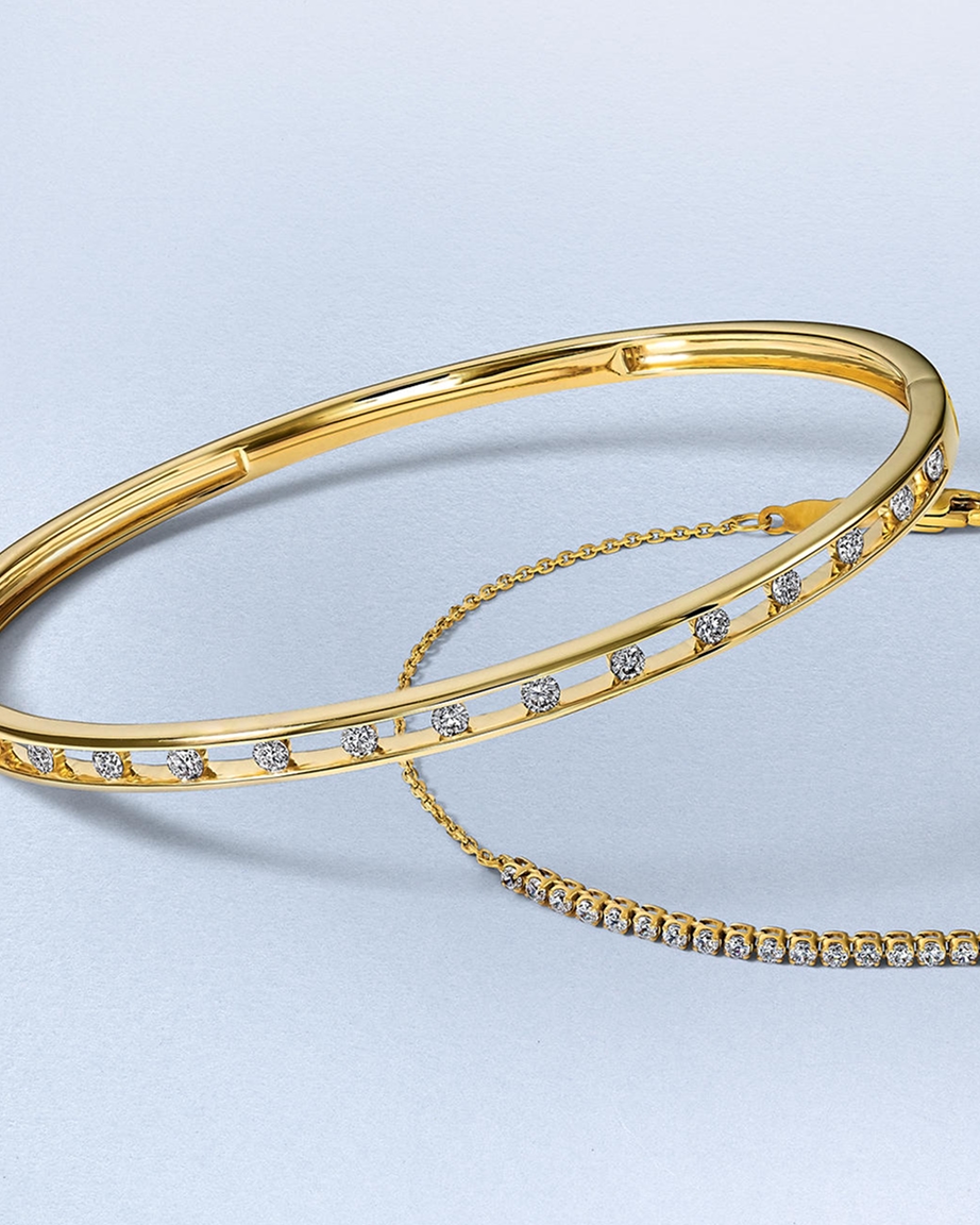 Two diamond inlaid, gold anniversary bracelets from KAY.