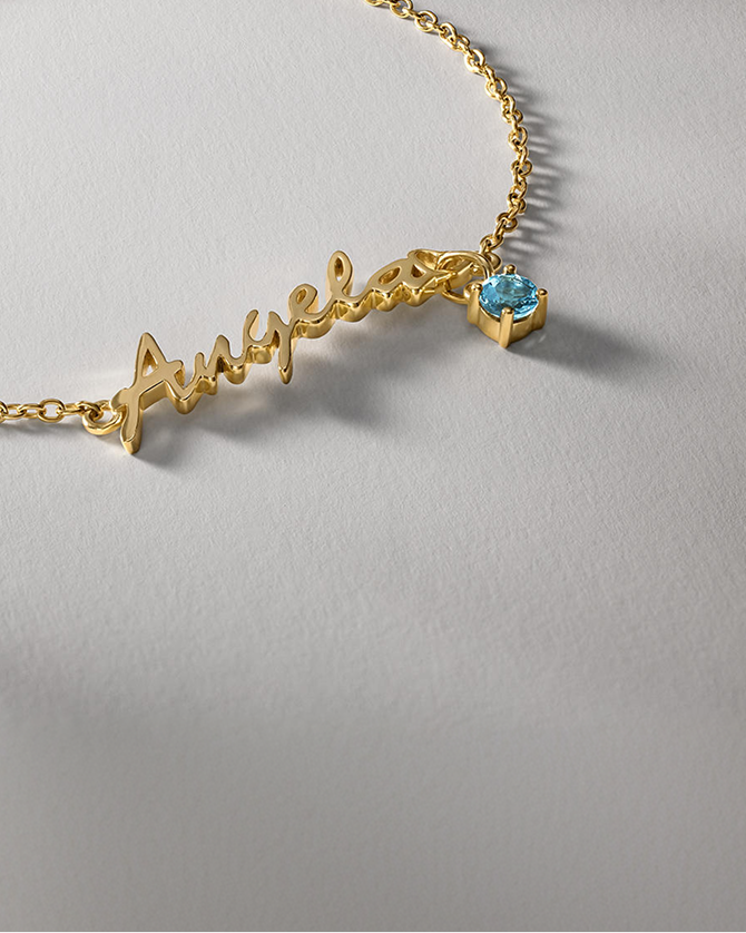 A personalized gold necklace with a birthstone pendant from KAY.