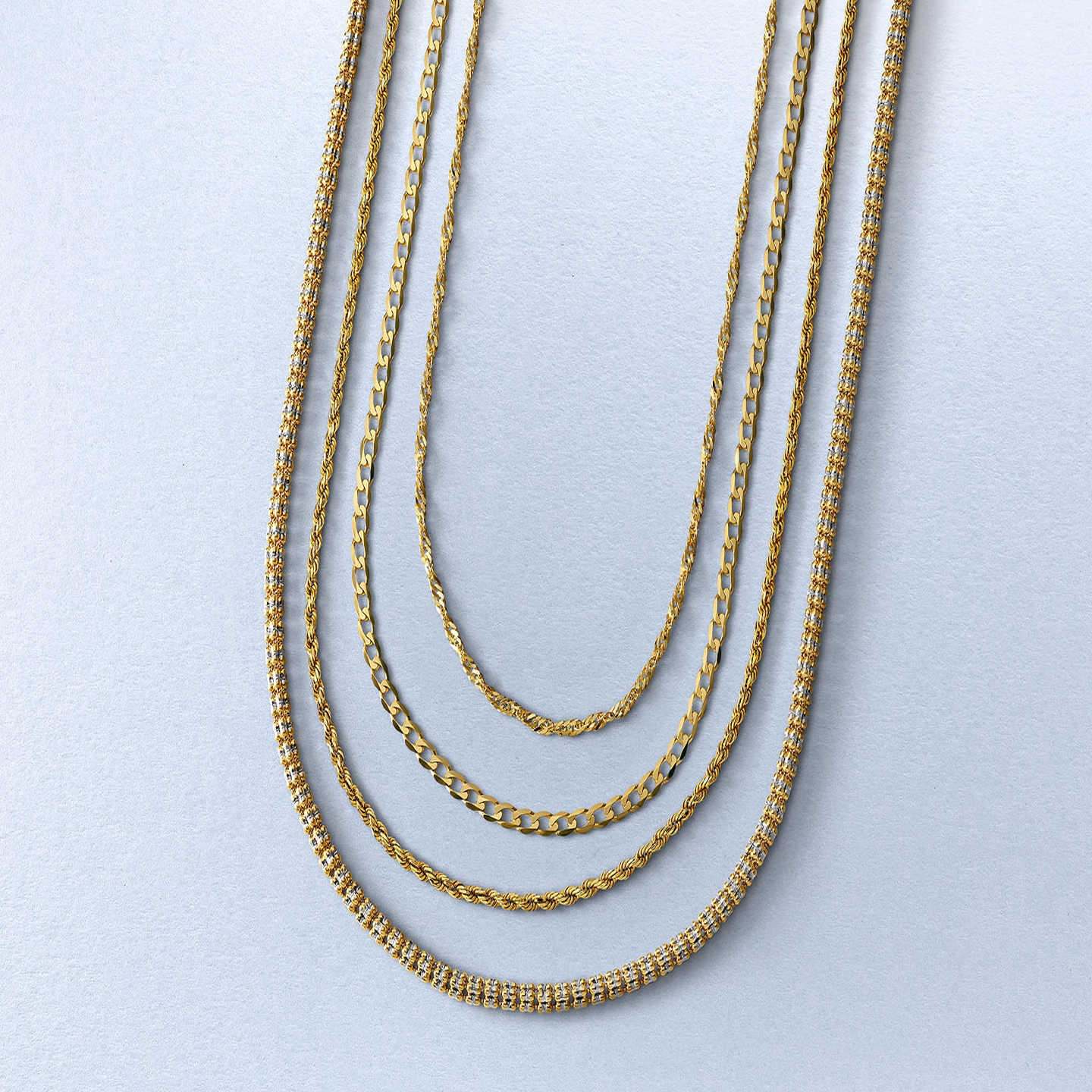 Four differing gold women's chains from KAY.