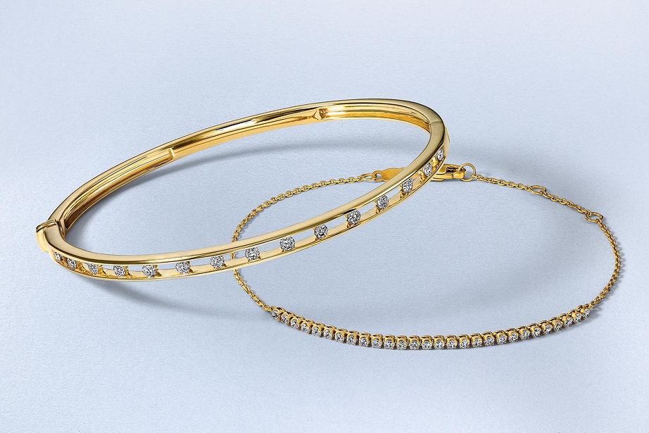 Two gold, diamond inlaid bangles from KAY.