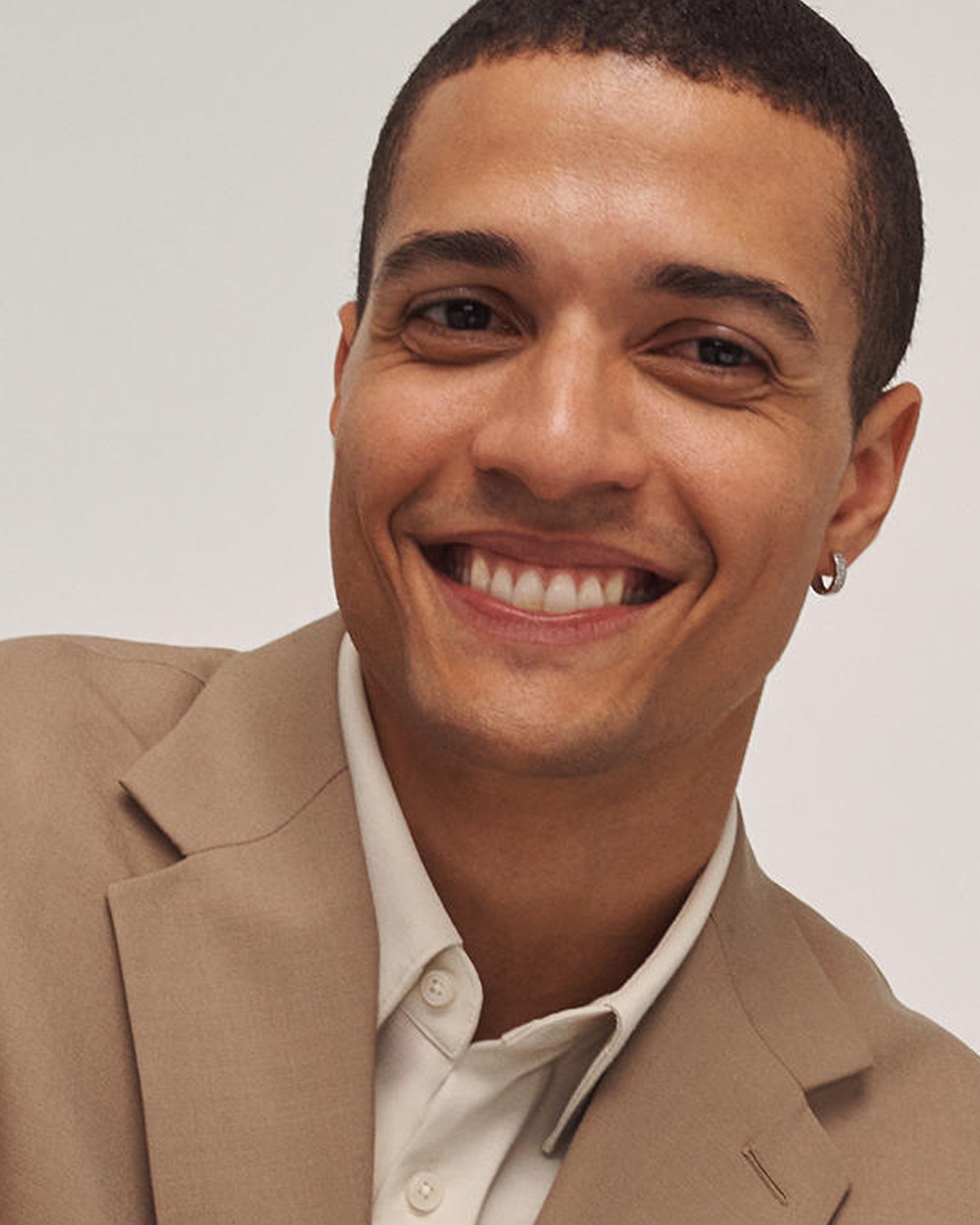A man sporting a single silver, loop earring from KAY.