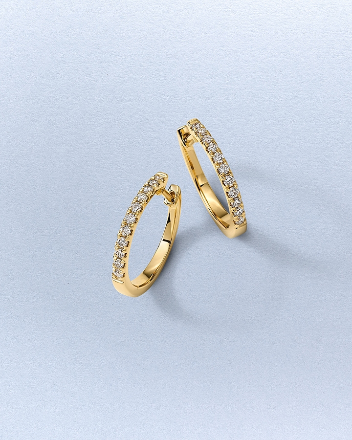 A pair of gold hoop earrings by KAY.