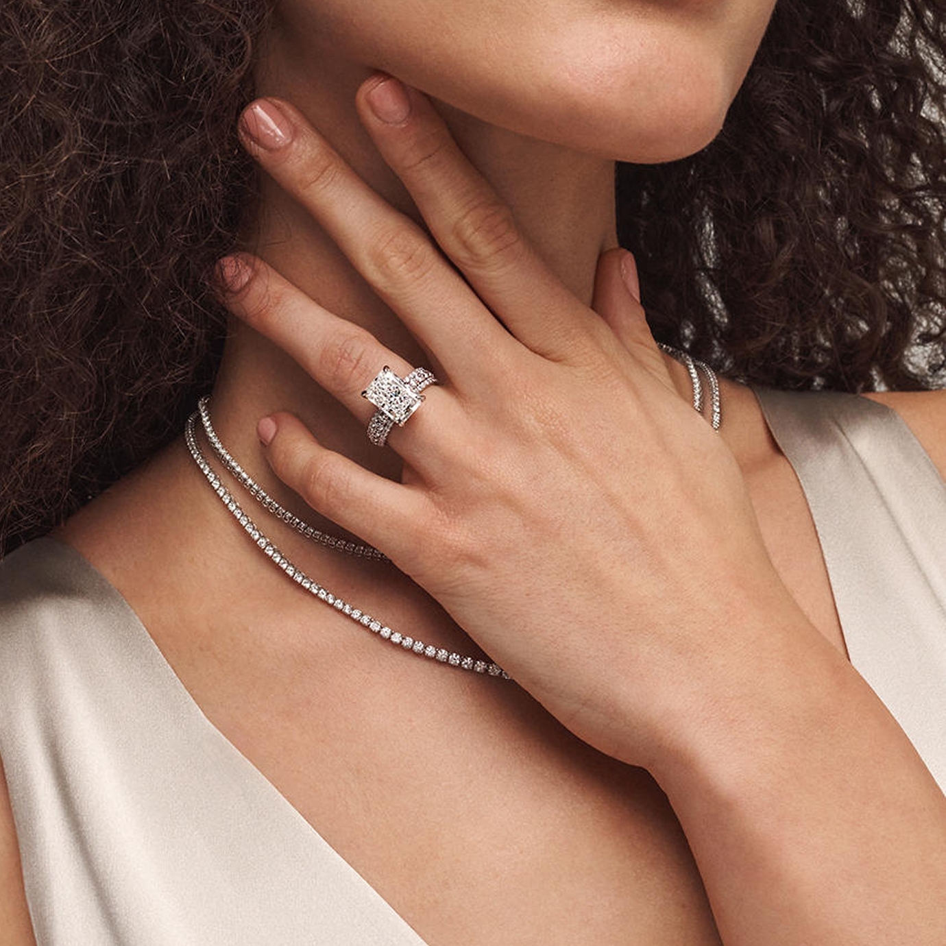 A woman wearing a KAY Signature diamond ring.