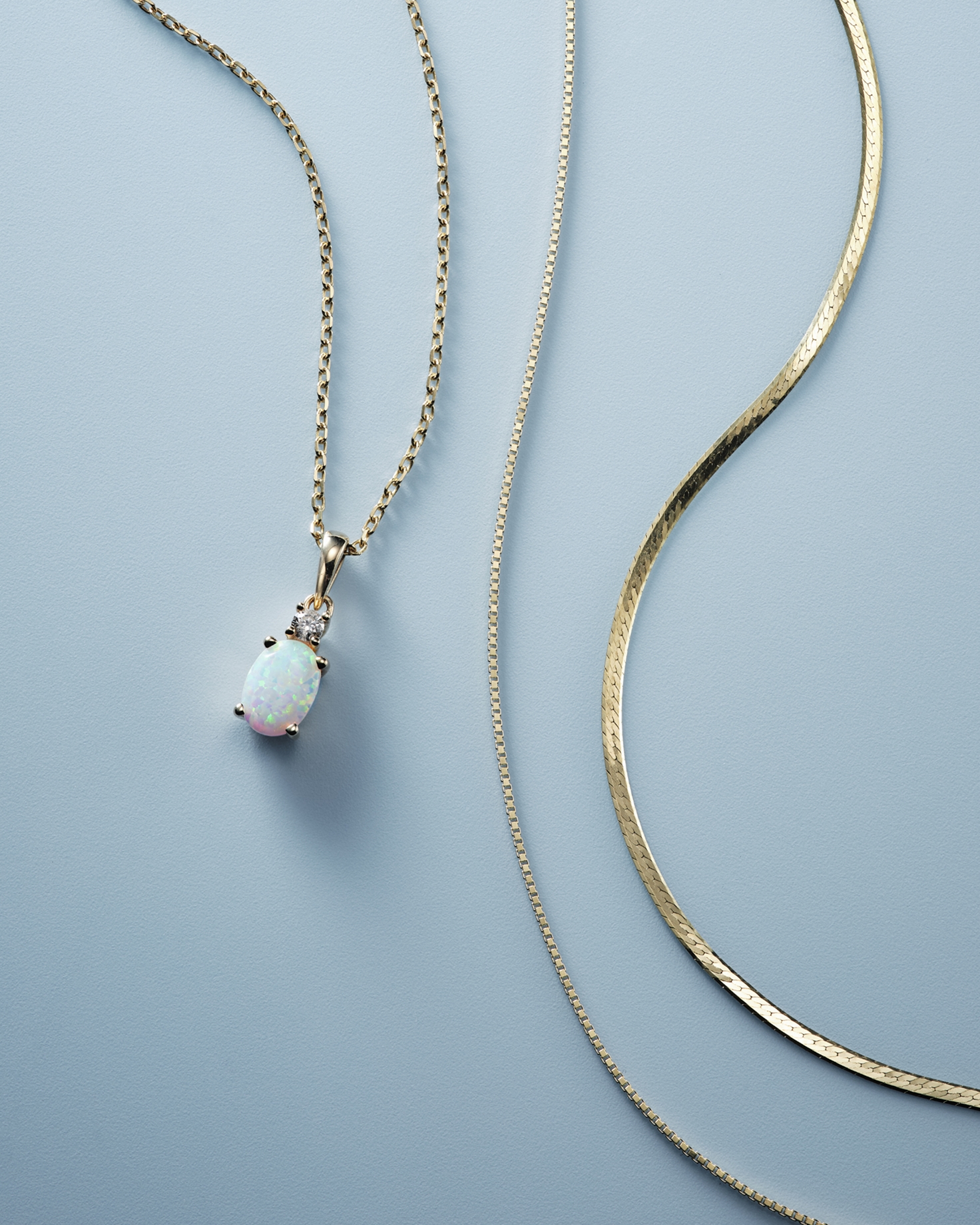 Three differing gold necklaces from KAY.