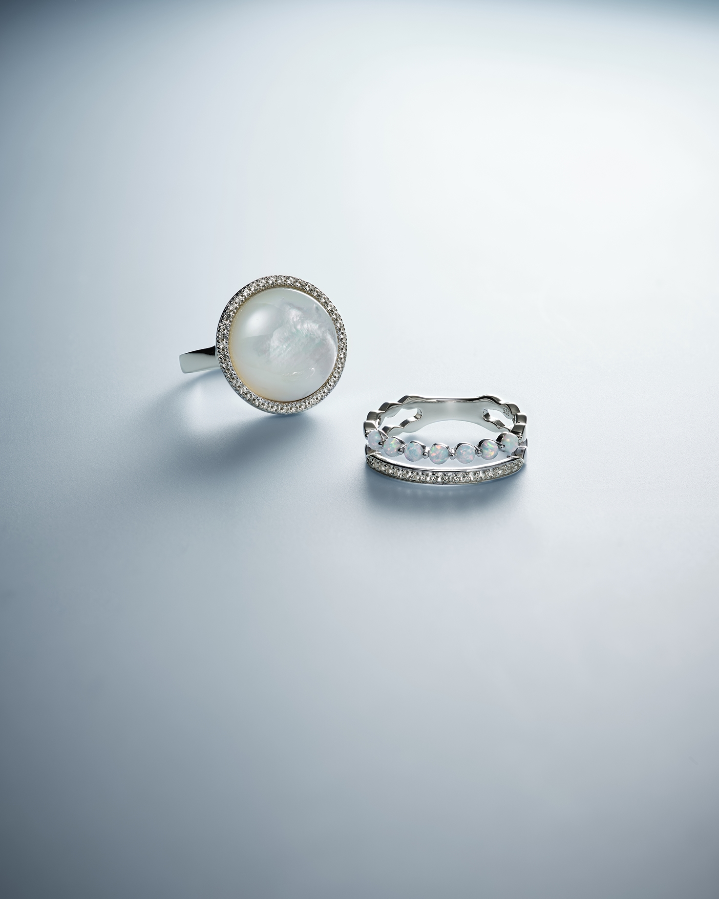 A pearl stud earring, with a stacking diamond ring from KAY.