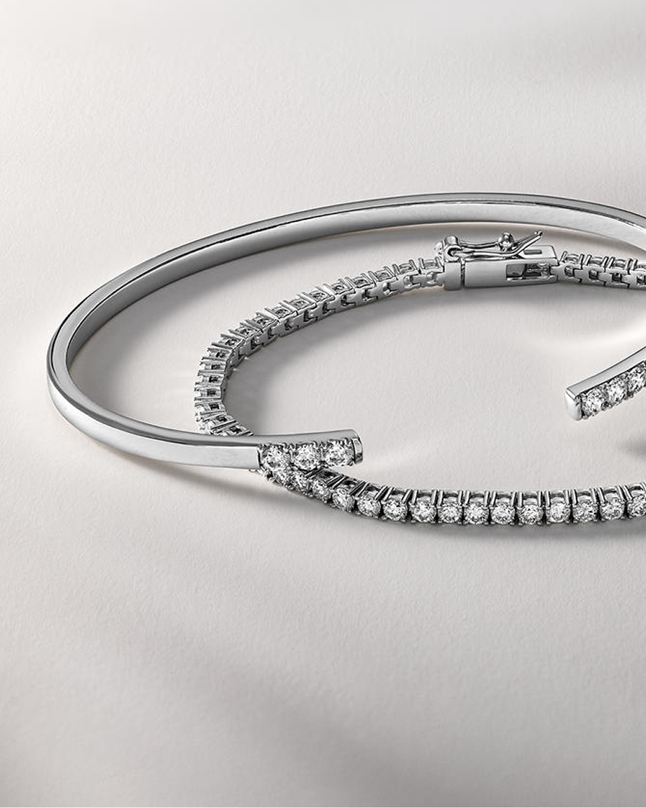 A white gold diamond bangle with a matching white gold diamond, tennis bracelet from KAY.
