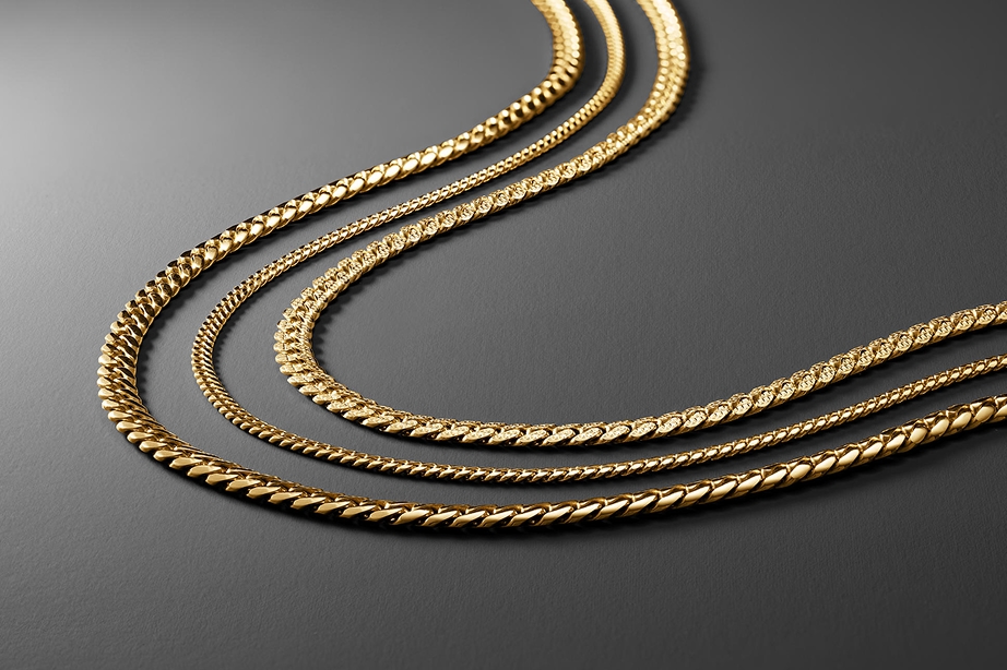 Three different types of gold chains laid out in a row from KAY.