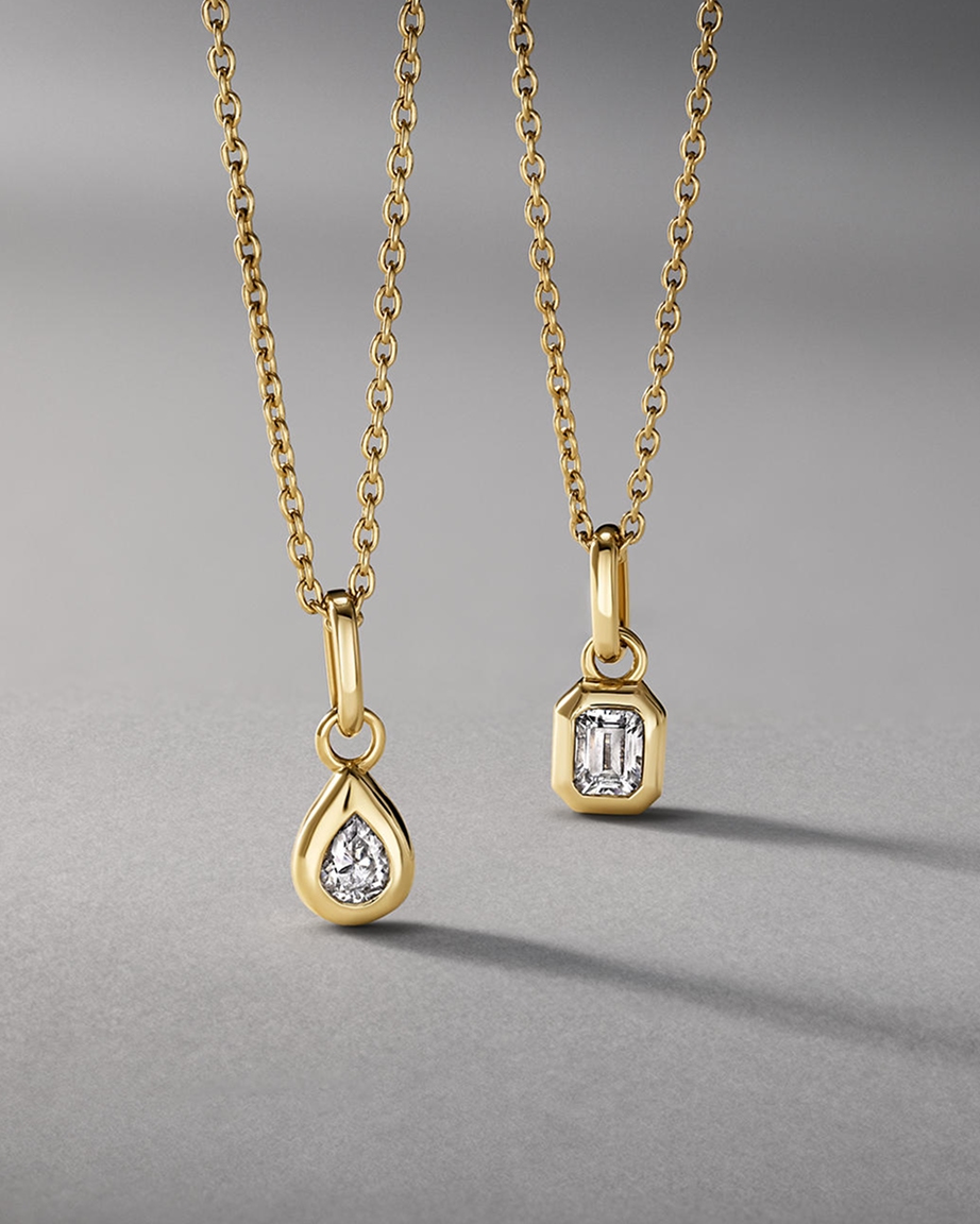 Two gold pendant necklaces from KAY.