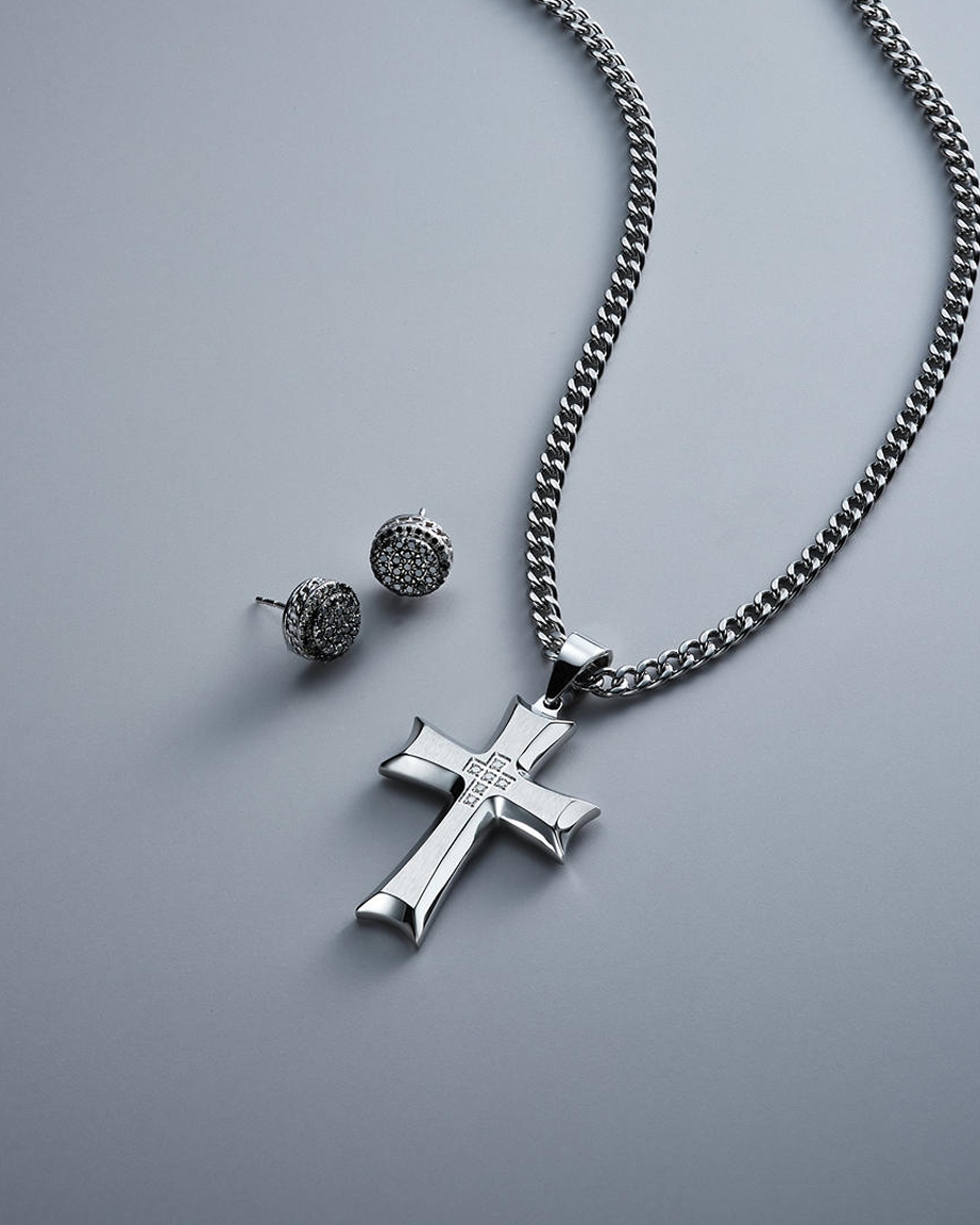 A religious, cross pendant, necklace with a set of matching stud earrings from KAY.