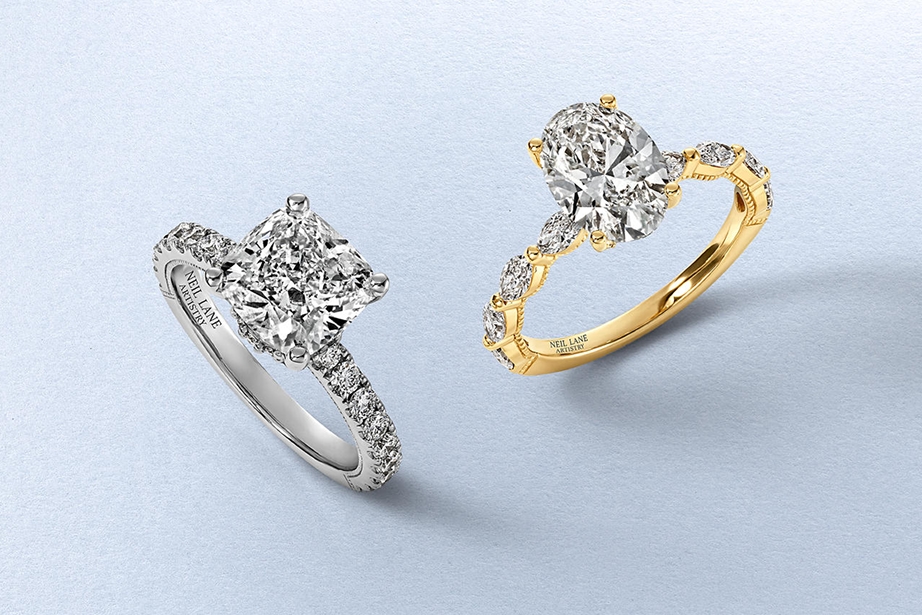 Two diamond engagement rings; One gold, and one silver, by KAY.