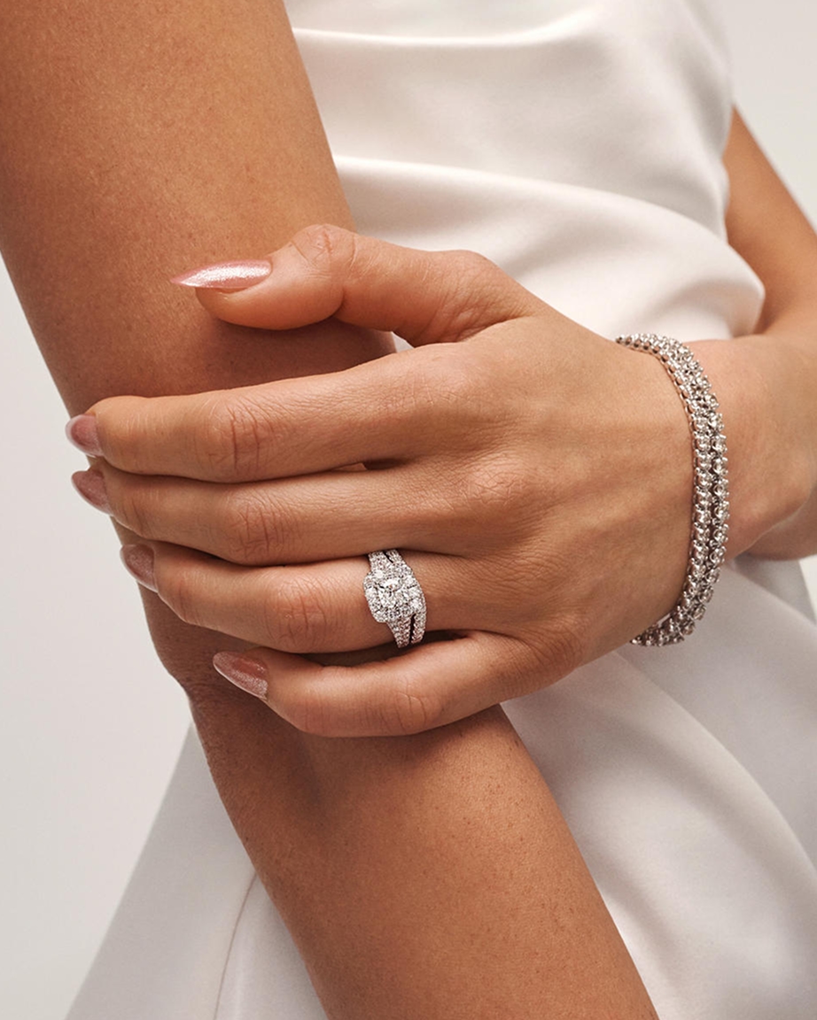 A woman wearing a diamond ring and bracelet from KAY.