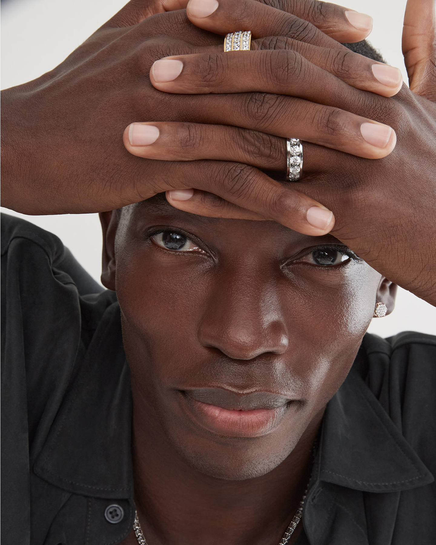 A man showing off his two diamond rings from KAY.