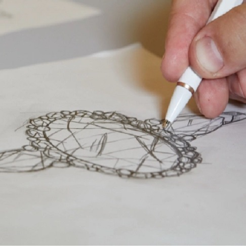 man sketching a custom engagement ring