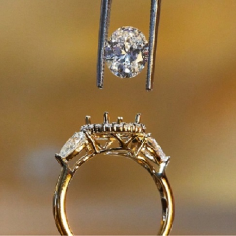 Diamond being set in engagement ring