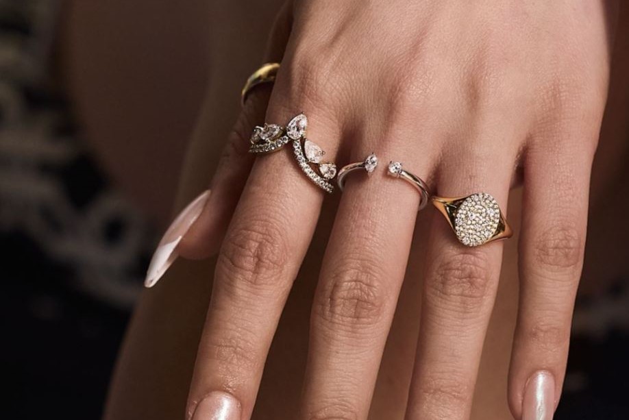 Image of hand on bannister with engagement ring