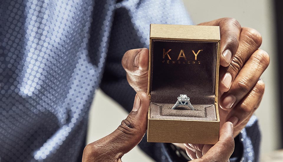 Men holding engagement ring box in hands. Learn about how to propose and more with our KAY education library