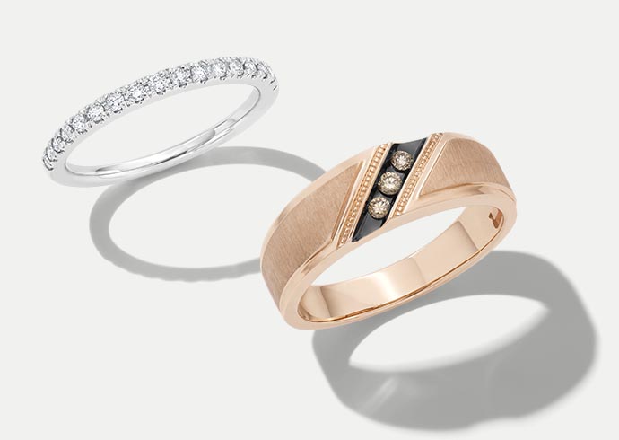 A pair of men's and women's KAY wedding bands