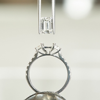 Diamond about to be set in engagement ring prong