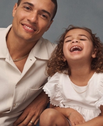 Image of father and daughter wearing chain necklaces