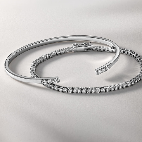 Two white gold, diamonds inlaid, stacking bracelets from KAY.