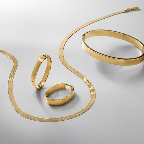 A set consisting of yellow gold earrings, a bracelet, and a necklace from KAY.