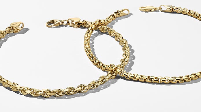 Image of two yellow gold chain bracelets